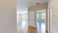 Located at 731 Federal Road in Brookfield, CT, this thoughtfully designed one-bedroom, one-bathroom residence offers a well-utilized single-floor layout with a clean, contemporary aesthetic throughout. The open-concept kitchen and living area serves as the heart of the home, featuring crisp white shaker cabinetry, a classic subway tile backsplash, stainless steel appliances including a gas range, built-in microwave, refrigerator, and dishwasher, and a generously sized island with a light granite-style countertop illuminated by pendant lighting. The kitchen flows naturally into the living area, where large windows allow abundant natural light to pour in, offering pleasant views of the surrounding greenery. Warm hardwood-style flooring runs consistently throughout the main living spaces, complementing the neutral, soft-toned walls. The bedroom is a comfortable, well-proportioned space with its own window overlooking the outdoors, providing a bright and airy feel. The full bathroom is well-appointed with a dark-toned vanity, white countertop, large mirror with overhead lighting, and a shower-tub combination. Additional features include a thermostat-controlled climate system and ample ceiling ventilation, making this a practical and polished living space.