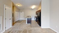 Located at 1430 Madison Ave in Indianapolis, Indiana, this one-bedroom, one-bathroom unit offers a practical and well-organized layout across a single floor. The open-concept kitchen serves as a central feature, showcasing rich dark-wood cabinetry, granite-style countertops, black appliances including a range and refrigerator, and a peninsula with an integrated sink — ideal for casual dining or food preparation. The kitchen flows seamlessly into the living area, which is finished with neutral-toned carpet and features a sliding glass door that allows natural light to fill the space and provides access to an outdoor view. The bedroom is a comfortable, carpeted room with a dedicated closet and a window that brings in additional natural light, creating a calm retreat. A full bathroom completes the unit, featuring a tub and shower combo with brushed hardware, a vanity with a marble-style countertop, and tile flooring. Throughout the unit, neutral wall tones and clean white trim contribute to a bright, cohesive aesthetic. The layout makes efficient use of the available space, offering a functional and comfortable living environment in the heart of Indianapolis.