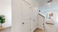 Located at 101 Mainland Lakes Dr in Bluffton, South Carolina, this two-story home offers a well-organized layout spread across two floors. The main level provides a comfortable foundation for daily living, featuring an open-concept dining room, kitchen, and living room. The kitchen is outfitted with white shaker cabinetry, granite countertops, subway tile backsplash, stainless steel appliances, and light hardwood-style flooring that extends throughout the main living areas. The dining area benefits from a sliding glass door that opens to a verdant backyard view, filling the space with natural light. A ceiling fan and additional windows in the living area enhance airflow and brightness.

The upper floor, which makes up the larger portion of the home, houses all three bedrooms, two full bathrooms, a dedicated laundry room, and a hallway. The generously sized primary bedroom features a bold accent wall, a ceiling fan, and large windows with outdoor views, alongside a spacious walk-in closet with wire shelving. The additional bedrooms are bright and well-proportioned, each with carpeted flooring and natural light. The bathrooms are finished with white vanities, undermount sinks, and clean, contemporary fixtures. A dedicated laundry room with full-size washer and dryer completes the upper level.