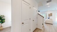 Located at 101 Mainland Lakes Dr in Bluffton, South Carolina, this two-story home offers a well-organized layout spread across two floors. The main level provides a comfortable foundation for daily living, featuring an open-concept dining room, kitchen, and living room. The kitchen is outfitted with white shaker cabinetry, granite countertops, subway tile backsplash, stainless steel appliances, and light hardwood-style flooring that extends throughout the main living areas. The dining area benefits from a sliding glass door that opens to a verdant backyard view, filling the space with natural light. A ceiling fan and additional windows in the living area enhance airflow and brightness.

The upper floor, which makes up the larger portion of the home, houses all three bedrooms, two full bathrooms, a dedicated laundry room, and a hallway. The generously sized primary bedroom features a bold accent wall, a ceiling fan, and large windows with outdoor views, alongside a spacious walk-in closet with wire shelving. The additional bedrooms are bright and well-proportioned, each with carpeted flooring and natural light. The bathrooms are finished with white vanities, undermount sinks, and clean, contemporary fixtures. A dedicated laundry room with full-size washer and dryer completes the upper level.