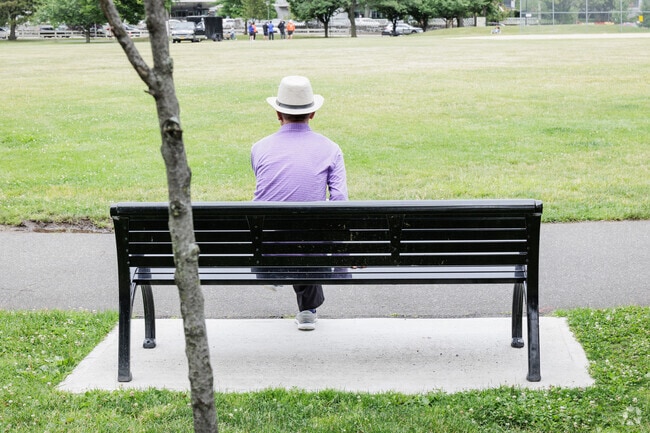 A man enjoys the benches at Constitution Park in Fort Lee, NJ.