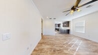 This 870 square foot single-story home in Huntsville, AL offers a well-designed living space with two bedrooms and two bathrooms. The interior is characterized by its modern aesthetic and efficient use of space. Throughout the home, wood-look flooring creates a warm and cohesive appearance, complemented by crisp white walls and crown molding.

The kitchen is a standout feature, boasting dark wood cabinetry, granite countertops, and stainless steel appliances. Pendant lighting over the island adds a touch of elegance. The open layout seamlessly connects the kitchen to the living areas, enhancing the sense of space.

The primary bedroom, measuring 130 square feet, provides ample room and features large windows for natural light. Both bathrooms are equipped with modern fixtures, including a shower-tub combo in one and a standalone shower in the other. 

The home includes a dedicated laundry room for convenience. Closet space is available in both bedrooms, ensuring adequate storage. The property's layout, as seen in the 3D floor plan, demonstrates an efficient use of the available square footage.

Overall, this property offers a blend of modern amenities and practical design, making it an attractive option for those seeking a compact yet comfortable living space.