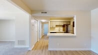 Located at 453 Golfview Blvd in Valparaiso, Indiana, this two-bedroom, one-bathroom residence offers a thoughtfully laid-out single-floor plan. The kitchen is a standout feature, equipped with stainless steel appliances including a refrigerator, electric range, microwave, and dishwasher. Gray shaker-style cabinetry pairs with white countertops, while light wood-look flooring and a peninsula with a stainless steel sink complete the space. The kitchen flows naturally into the living area, creating an open and connected feel. The living room is carpeted and offers ample wall space, with a sliding glass door providing outdoor access and views of the surrounding landscape. Both bedrooms are carpeted and finished in neutral tones. The primary bedroom includes a window for natural light, while the second bedroom features a wide closet with bifold doors for generous storage. The bathroom is clean and well-appointed, featuring a full tub and shower combination with classic white subway tile surround and brushed nickel fixtures. Throughout the home, a consistent neutral color palette and light-toned flooring create a bright, cohesive atmosphere suited for comfortable everyday living.