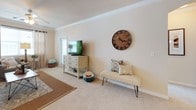 This single-floor residence offers a thoughtfully designed layout with a warm, neutral color palette carried throughout. The kitchen is a standout space, featuring rich cherry wood cabinetry, dark granite countertops, black appliances, and tile flooring. A peninsula with pendant lighting and bar seating connects the kitchen to the adjacent living and dining areas, making it well-suited for everyday use and entertaining. Crown molding adds a refined architectural detail to both the kitchen and living areas.

The living room is comfortable and well-lit, with carpet flooring, crown molding, a ceiling fan, and a window that brings in natural light. A dedicated dining area adjoins the space, providing room for a full table. The primary bedroom is generously sized with carpet flooring, a ceiling fan, and sliding glass doors leading to a private balcony. It includes a walk-in closet with built-in shelving. A second bedroom offers vaulted ceilings, a ceiling fan, a window, and a built-in desk area. The bathroom includes a walk-in shower with grab bars, rich cabinetry with a long vanity, and tile flooring. A dedicated laundry room with a full-size washer and dryer completes the layout.