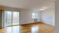 Located at 20 Scenic Dr in Croton-on-Hudson, NY, this one-bedroom, one-bathroom residence offers a well-organized single-floor layout. Warm hardwood floors run throughout the entire home, lending a cohesive and inviting character to every room.

The combined living and dining area is the centerpiece of the home, offering generous open space filled with natural light from multiple windows and a sliding glass door that opens onto a private balcony overlooking a scenic wooded landscape. Baseboard heating is present throughout, ensuring year-round comfort.

The kitchen is equipped with wood cabinetry, a gas range with overhead ventilation, and a full-size refrigerator, providing a functional cooking space with ample storage.

The spacious primary bedroom features gleaming hardwood floors, a natural light source from a dedicated window, and an impressive wall of sliding closet doors, offering substantial storage. Additional closets are distributed throughout the home, totaling four, further enhancing storage capacity.

The bathroom includes a full tiled tub-and-shower combination with classic white tile surround. A hallway connects the main living areas to the private quarters, creating a clear and practical flow throughout the home. This residence combines comfortable living with a tranquil, nature-adjacent setting.