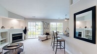 Located in Columbus, Ohio, this thoughtfully designed one-bedroom, one-bathroom residence offers a comfortable and functional single-floor layout. The open-concept living and dining area is a standout feature, boasting soaring vaulted ceilings that amplify the sense of space. A built-in fireplace with display shelving serves as a focal point, while large sliding glass doors and windows flood the room with natural light and provide direct access to a private balcony with outdoor views. Ceiling fans throughout enhance comfort and airflow.

The kitchen is well-equipped with white cabinetry, dark countertops, black appliances including a range, microwave, refrigerator, and dishwasher, and warm hardwood-style flooring. A breakfast bar connects the kitchen to the dining area, creating an ideal space for casual meals.

The bedroom is a peaceful retreat with plush carpeting, a ceiling fan, a natural light window, and a spacious walk-in closet with built-in shelving. The full bathroom features a tub-shower combination and wood-style flooring with a dark-countered vanity. Additional conveniences include a dedicated laundry area, utility room, and two closets for ample storage.