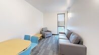 Located at 304 College Ave in Ithaca, NY, this three-bedroom, two-bathroom unit offers a efficiently organized single-floor layout well-suited for shared living. The interior follows a clean, contemporary design characterized by white walls, neutral tones, and carpeted flooring in the main living and bedroom areas, while the bathrooms feature light wood-look tile flooring.

The living room serves as the central shared space, accommodating a sofa, armchair, and a dining table with seating. A wall-mounted light fixture and a window with a roller shade provide both illumination and natural light, contributing to a bright, functional atmosphere.

Each of the three bedrooms maintains a consistent, minimalist aesthetic with light-colored walls, carpeted floors, and roller-shaded windows that allow natural light while providing privacy. The primary bedroom offers a more generous footprint, while the remaining bedrooms are compact yet practical. Furnishings include bed frames with light wood headboards and multi-drawer dressers.

Both bathrooms share an identical clean, modern design featuring glass-enclosed walk-in showers with brushed nickel fixtures, white surrounds, and light tile flooring. Towel bars and a wall mirror complete each bathroom. The overall design prioritizes functionality and simplicity throughout the unit.