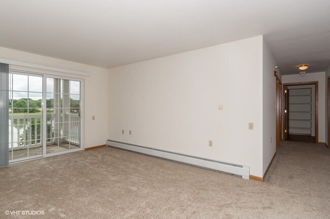 Living room with patio access - Prairie Oaks II Senior Apartments