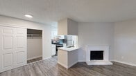 Located at 6305 Duck Creek Dr in Garland, Texas, this single-story unit offers a well-organized layout with updated finishes throughout. The open living area is anchored by a white-brick fireplace and flows seamlessly into the kitchen, which features white cabinetry, stainless steel appliances, a subway tile backsplash, and a peninsula with a quartz countertop and undermount sink. Wood-look plank flooring runs through the main living spaces, adding a clean, contemporary feel, while a textured ceiling provides a classic finishing detail.

The bedrooms are carpeted for comfort, with ceiling fans providing ventilation and natural light entering through blinded windows. The primary bedroom includes dual closets, offering generous storage. An additional room with wood-look flooring and a bright window serves well as a secondary bedroom, office, or flex space.

The bathroom is thoughtfully appointed with a quartz vanity countertop, an undermount sink, modern brushed-nickel fixtures, and well-lit mirrors. Additional storage is accessible via a walk-in closet nearby. The overall palette is neutral throughout, with light gray walls and white trim creating a bright, cohesive atmosphere well-suited for a variety of furnishing styles.