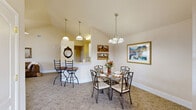 Located at 121 Margie Dr in Warner Robins, Georgia, this single-story, 2-bedroom, 2-bathroom home offers a well-designed layout with a warm and inviting atmosphere. The living room is highlighted by soaring vaulted ceilings and neutral-toned walls, creating an airy, open feel with plush carpeting underfoot. Adjacent to the living area, the combined dining room and kitchen space is ideal for everyday living and entertaining. The kitchen features white cabinetry, tile flooring, a full suite of appliances, and a peninsula with breakfast bar seating that seamlessly connects to the dining area, which is bathed in natural light from nearby windows. The primary bedroom is a generously sized retreat with carpet flooring, a ceiling fan, and access to a closet. Its en-suite bathroom includes both a soaking tub with a glass block window and a separate glass-enclosed shower. The second bedroom is bright and well-proportioned, also featuring carpet flooring, a ceiling fan, and large windows that invite natural light. A second full bathroom serves the remaining spaces. Hallways connect each room efficiently throughout the single-floor plan, contributing to the home's functional and comfortable design.