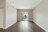 Located at 11405 Central Avenue in Chino, CA, this single-level residence offers a thoughtfully designed two-bedroom, two-bathroom floor plan with a comfortable and functional layout. The open-concept living and dining area is bathed in natural light, anchored by rich dark hardwood-style flooring and warm neutral-toned walls, creating an inviting ambiance. Sliding glass doors lead directly to a private patio, offering outdoor views of the surrounding community.

The kitchen is a standout feature, showcasing rich dark espresso cabinetry, granite-style countertops, and a full suite of stainless steel appliances including a gas range, built-in microwave, and refrigerator. A convenient in-unit stacked washer and dryer is tucked just off the kitchen area.

The primary bedroom provides a generous retreat with its own closet, while the second bedroom features plush carpet flooring and a large window with natural light. Both bathrooms are finished with wood-style flooring, clean white tiling, and tub-shower combinations, with one bathroom featuring a granite-topped vanity. Multiple closets throughout the home offer ample storage. The overall design balances practicality and comfort in a clean, modern aesthetic.