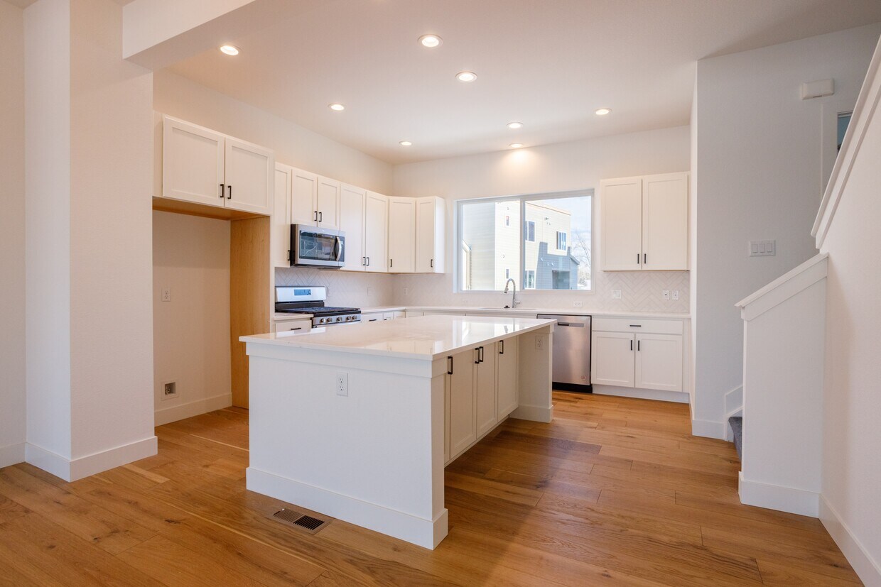 Kitchen with massive island and lot of cabinet space. - 888 S Valentia St
