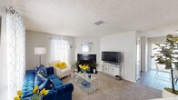 This two-story, 2-bedroom, 2-bathroom residence in Gretna, Louisiana offers a well-organized layout designed for comfortable everyday living. The living room serves as the centerpiece of the home, featuring a black-tiled fireplace, carpet flooring, and multiple windows dressed with sheer patterned curtains that allow natural light to fill the space. The kitchen is efficiently designed in a U-shaped layout, outfitted with white cabinetry, a white electric range, dishwasher, double-basin sink, and laminate wood flooring. A window above the sink brings in additional natural light. The primary bedroom is a calm, carpeted retreat equipped with a ceiling fan, dual closets, and a window for natural ventilation. The second bedroom, also carpeted, features windows with sheer curtains and a textured ceiling, offering a cozy and functional space. Both bathrooms are finished with tile flooring, vanities with warm-toned countertops, and shower-tub combinations. The layout across two floors provides practical separation of living and sleeping areas. Throughout the home, textured ceilings and neutral wall tones create a cohesive, understated aesthetic suited for a variety of interior styles.