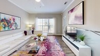 Located in Pensacola, FL, this thoughtfully designed one-bedroom, one-bathroom residence offers a comfortable and functional single-floor layout. The open-concept living room and kitchen area serves as the heart of the home, with the living space showcasing wood-style flooring, crown molding, a ceiling fan, and large windows that invite generous natural light and outdoor views. The galley-style kitchen is well-equipped with white cabinetry, dark countertops, black appliances including a range, refrigerator, microwave, and dishwasher, along with ample storage and a stainless steel sink. The bedroom features carpet flooring, a ceiling fan, and a closet, providing a quiet and restful retreat. A dedicated office space with carpet flooring and a bright window offers an ideal work-from-home setup. The full bathroom includes a white vanity with dark countertops, a large mirror with overhead lighting, and a tub-shower combination with wood-style flooring. A convenient in-unit laundry room houses a full-size washer and dryer. A hallway connects the rooms cohesively, completing this efficient and well-organized residence.