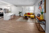 Located at 2293 Eglinton Ave E in Toronto, this well-appointed one-bedroom, one-bathroom unit offers a thoughtfully organized layout across a single floor. Light wood flooring flows throughout the space, creating a warm and cohesive feel from room to room.

The living room is a welcoming area highlighted by a distinctive decorative textured ceiling, a wall-mounted air conditioning unit, and a large window that fills the room with natural light and views of the surrounding neighbourhood. The open, airy feel of the living space extends into the hallways connecting each room.

The kitchen stands out with its modern renovation, featuring crisp white shaker cabinetry, white countertops, and a full suite of stainless steel appliances including a range, over-the-range microwave, dishwasher, and refrigerator. Light wood flooring and flush ceiling lighting complete the clean, functional design.

The primary bedroom is a comfortable retreat with a double closet, a wall-mounted AC unit, a natural light window, and neutral tones throughout. The bathroom is finished in a clean, minimalist style with a white vanity, mirror cabinet, and chrome fixtures.

Two hallways connect the rooms efficiently, contributing to the unit's practical and well-structured floor plan.