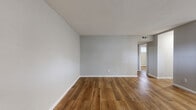 Located at 4702 Mangum Rd in Houston, TX, this single-story 2-bedroom, 1-bathroom home offers a practical and cohesive layout designed for comfortable everyday living. Warm-toned hardwood-style flooring runs consistently throughout the entire home, complemented by cool gray walls and crisp white trim that create a clean, modern aesthetic.

The spacious living room serves as the heart of the home, featuring natural light from a horizontal window and a paneled entry door, providing direct access to the exterior. The open sightlines connect seamlessly through hallways to the rest of the home.

Both bedrooms are well-proportioned, with the primary bedroom offering a generous footprint, a double-door closet, and a smart thermostat on the wall. The second bedroom also features a window with blinds, recessed lighting, and ample space. Each bedroom benefits from HVAC vents for climate control.

The hallways connect the living areas and bedrooms efficiently, maintaining a smooth flow throughout the single-floor layout. The bathroom is equipped with a tub and shower combination, accented by a decorative shower curtain.

Overall, this home presents a clean, updated interior with consistent finishes, making it a functional and inviting residence in Houston's 77092 area.