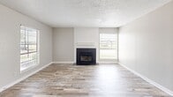 Located at 500 E Loop 820 in Fort Worth, TX, this single-floor, 3-bedroom, 1-bathroom unit offers a practical and comfortable layout throughout. The living room serves as the heart of the home, anchored by a tile-surround fireplace flanked by windows with exterior views, allowing natural light to fill the space. Wood-look laminate flooring runs consistently throughout, lending a cohesive and clean aesthetic to every room.

The kitchen is efficiently designed in an L-shaped configuration, featuring white cabinetry, granite-style countertops, a subway tile backsplash, and black appliances including a range, over-the-range hood, and dishwasher. A double-basin stainless steel sink sits beneath upper cabinets, maximizing storage and functionality.

The generously sized primary bedroom includes direct access to the full bathroom, built-in shelving with a closet rod, and a ceiling fan. The remaining two bedrooms are well-proportioned, with large windows that bring in natural light and views of the surrounding landscape. One bedroom features an electrical panel on the wall.

The full bathroom is outfitted with a white tub-shower combo and built-in shelving. A hallway and dedicated closet complete the layout. Textured ceilings are present throughout the unit.