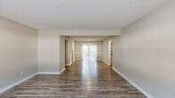 Located at 276 Upper Riverdale Rd in Jonesboro, GA, this single-floor, 3-bedroom, 1-bathroom home offers a practical and comfortable layout. The open living area is a standout feature, showcasing rich, dark wood-style flooring that extends throughout the main living spaces. Natural light pours in through a large sliding glass door at the far end of the room, creating a bright and welcoming atmosphere. Textured ceilings add a classic touch throughout the home.

The kitchen is efficiently designed with white cabinetry, a gas range, a full-size refrigerator, a stainless steel sink, and wood-style flooring, providing a clean and functional cooking space.

The three bedrooms are carpeted for comfort and each features a window that brings in natural light and outdoor views of surrounding greenery. The primary bedroom is notably spacious, complete with a ceiling fan and a closet with built-in shelving. The additional bedrooms also include ceiling fans, enhancing year-round comfort.

The bathroom is well-appointed with a double-sink vanity, a large mirror, and wood-style flooring, offering ample counter space. Two closets provide additional storage throughout the home. The layout is completed by a connecting hallway that ties all rooms together efficiently.