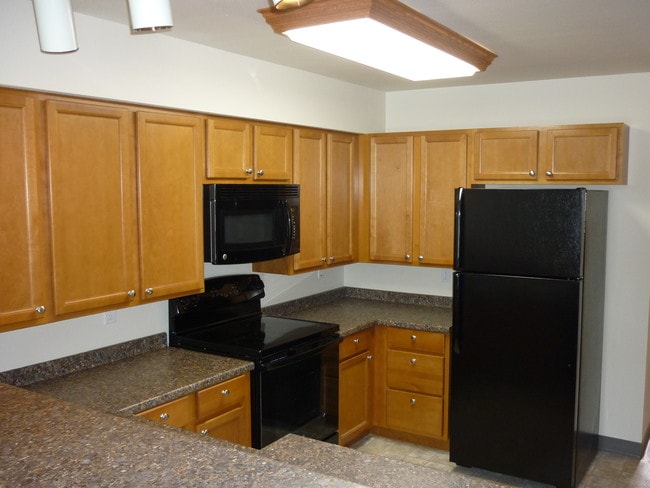 Kitchen with plentiful storage - The M Apartments