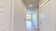 Located along RM-620 in Austin, TX, this well-appointed single-floor home offers three bedrooms, two full bathrooms, and a thoughtfully designed open-concept layout. Light wood flooring flows consistently throughout the space, creating a clean and cohesive aesthetic.

The kitchen is a standout feature, showcasing rich dark wood cabinetry that extends to the ceiling, quartz countertops, a full suite of stainless steel appliances, and a subway tile backsplash. A spacious island with pendant lighting serves as both a functional workspace and casual dining area, opening seamlessly into the living room, which features a ceiling fan and access to natural light via windows and a glass-panel door.

The generously sized primary bedroom includes multiple windows with outdoor views and connects to a well-organized walk-in closet with dual hanging rods and built-in shelving. The en-suite primary bathroom offers a glass-enclosed marble tile shower, a dark wood vanity with quartz countertop, and direct closet access. The second bathroom features a full soaking tub with tiled surround, a dual-sink vanity, and ample storage. Additional bedrooms are bright and inviting, each with large windows overlooking surrounding greenery.