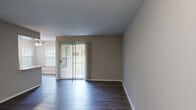 Located at 5341 Columbia Rd in Columbia, Maryland, this one-bedroom, one-bathroom residence offers a well-designed, efficiently laid-out single-floor living space. The combined kitchen and living room serves as the heart of the home, featuring dark hardwood-style flooring, neutral gray walls, and a sliding glass door with vertical blinds that fills the area with natural light and provides direct outdoor access. A side window further brightens the space.

The kitchen is outfitted with white shaker-style cabinetry, light countertops, and a full suite of stainless steel appliances, including a refrigerator, electric range, and over-the-range microwave, all set against a classic tile backsplash.

The bedroom is carpeted for comfort and receives natural light through a window with blinds. It connects directly to a dedicated walk-in closet with built-in shelving, as well as providing easy access to the full bathroom. The bathroom features a white vanity with an integrated sink, a tiled shower-tub combination, and clean, neutral finishes throughout.

A separate in-unit laundry room houses a full-size washer and dryer with wire shelving above for added storage. The entrance provides a smooth transition into the main living areas, completing this thoughtfully organized and move-in-ready residence.