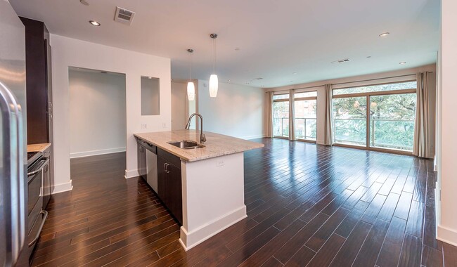 Open layout with upgraded lighting and breakfast bars - 1045 On The Park Apartment Homes
