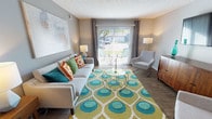 This thoughtfully designed single-floor apartment at Ashtonbrook Apartments in Louisville, KY offers a comfortable and contemporary living experience. The open-concept living area features wood-style flooring, neutral gray walls, and a sliding glass door that fills the space with natural light while providing direct access to a private outdoor patio. The kitchen is well-appointed with gray cabinetry, granite-style countertops, and a full suite of stainless steel appliances, including a refrigerator, range, microwave, and dishwasher, all set over durable wood-style flooring. The unit includes two bedrooms, each carpeted and featuring natural light from windows with blinds. The primary bedroom offers generous proportions, while the second bedroom provides a comfortable, cozy retreat. Two bathrooms serve the unit — one featuring a full tub-shower combination, and the other a vanity with granite-style countertops, gray cabinetry, and wood-style flooring. Consistent design elements throughout, including gray tones, modern fixtures, and textured ceilings, tie the space together into a cohesive and functional home.