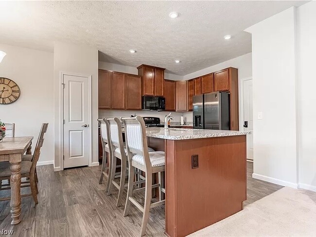 Cherry cabinetry and granite countertops. Luxury vinyl flooring. - 3383 Jackson Park Dr NW