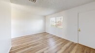 This 480 square foot apartment in Bakersfield, CA offers a thoughtful layout maximizing its compact space. The single-story unit features one bedroom and one bathroom, making it suitable for individuals or couples. The living area showcases modern wood-look flooring, creating a warm and inviting atmosphere. Large windows in the living room and bedroom allow ample natural light, enhancing the sense of space.

The kitchen, while compact, is efficiently designed with ample cabinetry, a double sink, and full-sized appliances. The wood-toned cabinets contrast nicely with the light countertops, maintaining a cohesive look with the flooring. The bathroom features a shower-tub combo with sliding glass doors, offering both practicality and a clean aesthetic.

The bedroom, measuring 120 square feet, includes a sliding closet door for storage. The room is finished with plush carpeting, adding comfort underfoot. Throughout the apartment, white walls and a textured ceiling contribute to a bright, open feel. The property's layout, with its combined kitchen and living area, maximizes the available space, creating a functional and contemporary living environment.