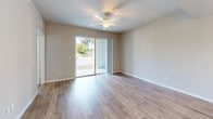 Located at 3305 Grant Cove Circle in Cape Coral, Florida, this well-appointed 2-bedroom, 2-bathroom residence offers a comfortable and functional single-floor layout. A welcoming hallway with wood-look flooring leads into the open-concept living, dining, and kitchen area, which serves as the heart of the home. The kitchen is a standout feature, showcasing tall dark espresso cabinetry extending to the ceiling, granite countertops, a central island with a sink, and a full suite of black appliances including a range, microwave, dishwasher, and refrigerator. Recessed lighting throughout enhances the bright, clean aesthetic. The living and dining areas flow seamlessly together, providing a spacious and versatile environment. Both bedrooms are comfortably sized, featuring plush carpet, neutral tones, and windows that invite natural light. The primary bedroom includes its own en-suite bathroom with a granite-topped double vanity, dark wood cabinetry, and a walk-in shower. The second bathroom offers a tiled tub-shower combination and wood-look flooring. A dedicated in-unit laundry room with washer and dryer adds everyday convenience. Five closets provide generous storage throughout. The unit also includes a private patio, perfect for enjoying the Florida climate.