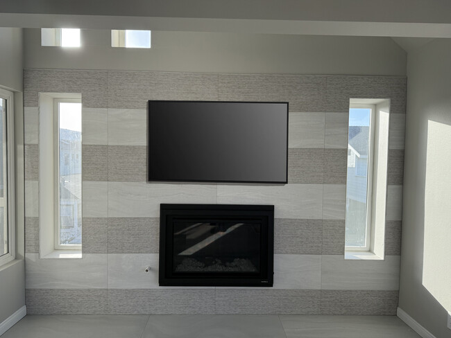 Custom tiled fireplace in living with lots of natural light and an ocean view. - 209 39th St