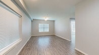 Located at 600 E Marble St in Wylie, TX, this single-story, 2-bedroom, 1-bathroom home offers a well-designed layout with modern finishes throughout. The combined kitchen and living area serves as the heart of the home, featuring rich dark espresso cabinetry, light granite countertops, a peninsula island for additional workspace, and a full suite of stainless steel appliances including a range, over-the-range microwave, and dishwasher. Wood-look luxury vinyl flooring runs consistently throughout the entire home, adding warmth and cohesion to every room.

The living area is bright and open, with multiple windows fitted with blinds allowing natural light to fill the space. Ceiling fans are installed in the living and bedroom areas, contributing to year-round comfort. The spacious primary bedroom includes a double-door closet and ample room to furnish comfortably. The second bedroom also benefits from natural light through a large window and its own ceiling fan. The full bathroom is clean and functional, featuring a tiled tub/shower combination with brushed nickel fixtures and cabinetry for storage. Neutral gray tones on the walls throughout create a calm, move-in-ready aesthetic ideal for a variety of décor styles.