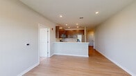Located at 264 Passaic Ave, Unit 304 in Fairfield, NJ, this well-appointed two-bedroom, two-bathroom residence offers a thoughtfully designed single-level layout. The open-concept kitchen and living area serves as the heart of the home, featuring rich dark-wood cabinetry, a subway tile backsplash, light quartz countertops, and a full suite of stainless steel appliances including a gas range, microwave, and French door refrigerator. A peninsula counter provides additional workspace and casual seating. Light hardwood-style flooring flows throughout the main living areas and bedrooms, lending a clean, contemporary feel. The primary bedroom is generously sized, offering ample space and a dedicated closet. The second bedroom features plush carpeting and large windows that invite plenty of natural light and outdoor views. Both bathrooms are finished with neutral tones; one features a frameless glass-enclosed walk-in shower with white subway tile and a rainfall showerhead. A connecting hallway with recessed lighting ties the layout together seamlessly. Neutral wall tones throughout create a bright, versatile backdrop suited to a variety of décor styles.