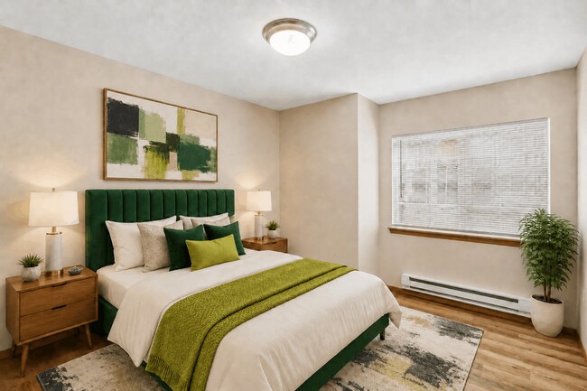 Un dormitorio confortable con luz natural y espacio suficiente para una completa distribución del mobiliario. - Tudor Village at the Mall Apartments