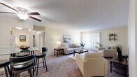 This thoughtfully designed one-bedroom, one-bathroom residence at 100 West St, Unit D3 in Rocky Hill, CT offers a comfortable and functional single-floor layout. The living room is bright and welcoming, featuring plush carpeting, a textured ceiling, and a large sliding glass door with vertical blinds that fills the space with natural light and provides outdoor views. A ceiling fan adds practicality, and the open flow into the dining area — complete with a bistro-style table and bar seating — makes the layout ideal for everyday living and entertaining. The generously sized bedroom offers ample room to furnish comfortably, with soft carpeting underfoot, a large window for natural light, and two mirrored sliding closet doors that enhance the sense of space. Warm, neutral tones on the walls carry throughout the unit, creating a cohesive and calm ambiance. The bathroom features classic white tile surrounding a full soaking tub and shower combination, with wood-look flooring that adds a modern touch. The kitchen, visible in the floor plan, is efficiently arranged to maximize utility. Overall, this residence delivers a clean, functional, and comfortable living environment with practical storage and pleasant natural light throughout.