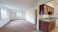 This two-bedroom, one-and-a-half-bathroom residence in Westland, Michigan is thoughtfully laid out across a single floor, offering a functional and comfortable living arrangement. The spacious living room features neutral carpeting and a large window that fills the space with natural light, creating a bright and welcoming atmosphere. Adjacent to the living area, a dedicated dining space includes tile flooring and a ceiling fan, providing a comfortable area for everyday meals.

The galley-style kitchen is well-appointed with rich, dark wood cabinetry lining both sides, offering generous storage and counter space. Granite-patterned countertops complement the cabinetry, while white appliances including a range and refrigerator complete the setup. Tile flooring runs throughout the kitchen for easy maintenance.

Both bedrooms are carpeted and receive ample natural light through sizable windows. One bedroom features a closet, adding practical storage. The full bathroom includes a wood-toned vanity with under-sink storage, a large mirror, a shower-tub combination, and classic mosaic tile flooring. The half bathroom offers a similarly styled vanity and matching tile flooring, providing added convenience for residents and guests alike.
