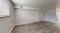 Located at 1308 W Covington Ct in Peoria, IL, this 2-bedroom, 1-bathroom unit offers a thoughtfully laid-out single-floor design. Light-toned luxury vinyl plank flooring runs consistently throughout the space, lending a clean, cohesive aesthetic to every room. The living room is spacious and open, featuring a front entry door, overhead ventilation, and a sliding glass door that opens to a private patio — bringing in natural light and providing convenient outdoor access. The kitchen is well-appointed with rich dark cabinetry, light granite-style countertops, and a full suite of white appliances including a refrigerator, dishwasher, electric range, and built-in range hood. Both bedrooms are bright and comfortable, each featuring windows with blinds that allow natural light while maintaining privacy. The primary bedroom offers a generous footprint, clean white walls, and ample room for furnishings. The full bathroom is finished in a crisp, all-white palette with a dark vanity, a combined tub and shower, and matching LVP flooring. A connecting hallway ties the layout together efficiently. Overall, the unit presents a clean, move-in-ready environment with consistent modern finishes throughout.