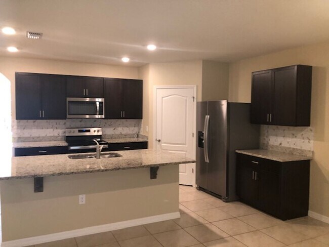 Building Photo - 4/2 with great FENCED in yard and upgraded!