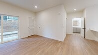 Located at 15 Ore Bank Rd in Dillsburg, PA, this well-designed one-bedroom, one-bathroom unit offers a thoughtfully organized single-floor layout. The open-concept kitchen and living area serves as the heart of the home, featuring a central island with crisp white quartz countertops, a stainless steel sink, and sleek gray shaker-style cabinetry. Stainless steel appliances—including a refrigerator, range, and over-the-range microwave—complement the modern aesthetic. Pendant lighting above the island adds a polished touch, while light wood-look flooring and recessed lighting create a bright, welcoming ambiance throughout. A sliding glass door in the living area allows natural light to fill the space and provides access to the outdoors. The bedroom is a comfortable, private retreat finished with plush carpeting and a window that brings in natural light. A louvered closet door adds a classic detail to the room. The full bathroom includes a tub-shower combo with clean white surrounds. A dedicated laundry area houses a full-size top-load washer and dryer, adding everyday convenience. Clean white walls, modern black hardware accents, and consistent finishes throughout give this unit a cohesive and contemporary feel.