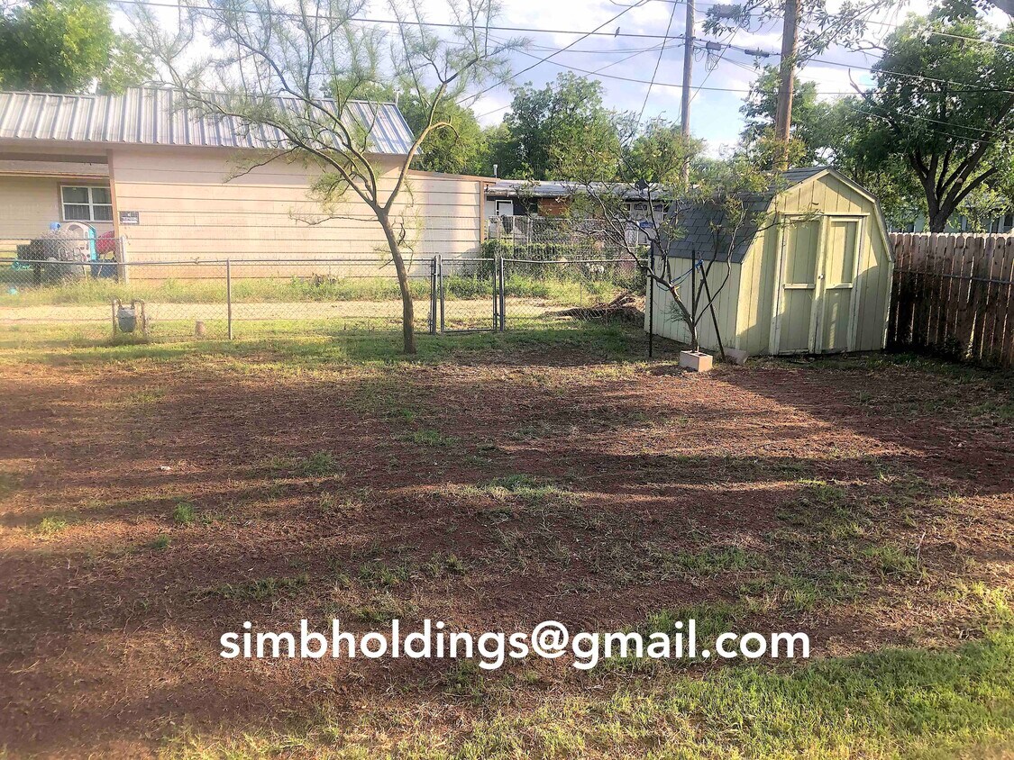 Fully fenced backyard has been recently leveled for a safe outdoor play space. Additional storage in extra building. - 145 Windham St