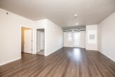 Located at 850 Twixt Town Rd NE in Marion, Iowa, this single-floor unit offers a clean, modern design with a thoughtful layout throughout. The open living and dining area is finished with durable wood-look flooring and neutral walls, creating a bright and versatile space. Exposed ductwork adds an industrial accent, while a glass-paned door leads to a private balcony that invites natural light and outdoor views of the surrounding treeline.

The kitchen is well-equipped with an L-shaped layout, dark gray cabinetry extending to the upper walls, white countertops, a stainless steel sink, and a full suite of stainless steel appliances including a range, microwave, and dishwasher. Recessed lighting completes the functional and stylish kitchen environment.

The bedrooms feature plush carpeting, large windows with views of mature trees, and generous closet space—including a spacious walk-in closet with wire shelving for ample storage. The bathroom is clean and efficient, offering a full tub and shower combination with chrome fixtures and wood-look flooring. A dedicated in-unit laundry room comes equipped with a full-size washer and dryer, adding everyday convenience. Throughout, the space maintains a fresh, move-in-ready atmosphere with a consistent neutral palette.