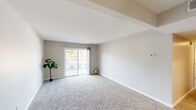 This 2-bedroom, 2-bathroom single-floor residence in Fort Wayne, Indiana offers a well-organized and functional layout with a neutral, move-in-ready aesthetic throughout. The combined living and dining area is bright and open, featuring plush carpet, soft neutral wall tones, and a sliding glass door that fills the space with natural light and provides direct access to a private patio with outdoor views.

The kitchen is a standout feature, equipped with warm wood cabinetry, granite-style countertops, stainless steel appliances including a range and refrigerator, hardwood-style flooring, and recessed lighting — creating a practical yet polished cooking space.

Both bedrooms are carpeted and finished with the same clean, neutral palette, offering a calm and restful atmosphere. The primary bedroom provides a comfortable footprint with ample room for furnishings. Each bedroom benefits from generous closet space, and the unit overall includes five closets, offering exceptional storage throughout.

The two bathrooms are cleanly appointed with tub/shower combinations, granite-topped vanities, and wood-style flooring. A hallway connects the main living areas to the bedrooms and bathrooms, contributing to a logical and efficient floor plan. The overall ambiance is bright, clean, and understated — well-suited for comfortable everyday living.