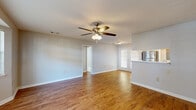 Located at 539 N Westover Blvd in Albany, Georgia, this single-floor residence offers a well-organized layout with a cohesive blend of comfort and functionality. The open living area is a highlight of the home, featuring warm hardwood-style flooring that extends throughout the main spaces, neutral-toned walls, and a ceiling fan with light kit that promotes airflow and ambiance. Natural light filters in through a set of exterior-facing doors, brightening the room considerably.

The kitchen is efficiently designed with honey-toned wood cabinetry, stainless steel appliances including a refrigerator, range, and microwave, as well as a light countertop surface and a pass-through opening that connects it visually to the living area.

A standout feature is a dedicated room with a charming bay window, allowing abundant natural light to pour in — ideal as a dining area or sitting room. The bedrooms are carpeted for comfort, each equipped with ceiling fans and generous closet space, including one room with a sizable reach-in closet with rod storage.

The bathrooms are functional and clean in design. One features a long vanity with dual sink capacity, warm wood cabinetry, and a tub, while the second offers a tub-shower combo with hardwood-style flooring and a single vanity. Throughout the home, the consistent finishes and practical layout make for a comfortable, move-in-ready living environment.