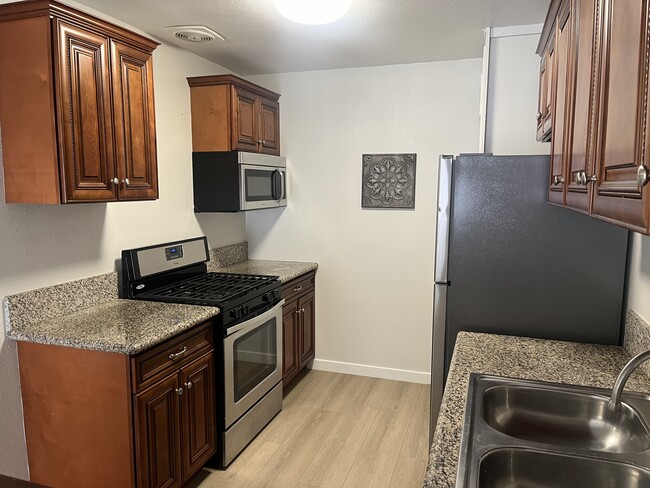 Kitchen has Stainless Steel Range/Stove, microwave and Refrigerator - 375 Vernon Drive