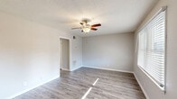 Located at 526 Carl Street in Gastonia, NC, this single-story, one-bedroom, one-bathroom home offers a practical and well-organized layout across a compact but efficiently designed floor plan. The living room serves as the welcoming focal point of the home, featuring durable gray luxury vinyl plank flooring, a ceiling fan with light fixture, and a window fitted with blinds that allows natural light to filter in. The space flows into a combined dining and kitchen area, where gray shaker-style cabinetry pairs with light granite-look countertops and stainless steel appliances, including a refrigerator and electric range with an overhead vent hood. The bedroom provides a comfortable retreat, carpeted for warmth and equipped with its own ceiling fan, a closet, and a window overlooking the exterior. A full bathroom features LVP flooring, a toilet, and a bathtub/shower combination. A dedicated laundry room adds everyday convenience. Throughout the home, textured ceilings, neutral gray walls, and white trim create a clean, cohesive aesthetic that is both functional and move-in ready.