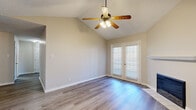 Located at 500 Napa Valley Dr in Little Rock, Arkansas, this 2-bedroom, 2-bathroom home offers a well-designed single-floor layout with a variety of appealing architectural details. The living room serves as the heart of the home, showcasing soaring vaulted ceilings, a ceiling fan, a tile-surround fireplace, and elegant French doors that invite natural light and outdoor access. Durable wood-look flooring runs throughout the main living areas, adding warmth and continuity.

The galley-style kitchen is efficiently laid out, featuring rich wood cabinetry, granite-look countertops, a skylight, and a breakfast bar peninsula that opens toward the dining area. White appliances include a range, microwave, dishwasher, and refrigerator.

Both bedrooms are generously sized with plush carpeting, ceiling fans, and ample natural light from well-placed windows. The primary bedroom offers a comfortable, private retreat. The two bathrooms each feature tub/shower combinations with tile surrounds, wood-look flooring, and warm cabinetry with granite-style countertops.

A dedicated closet provides additional storage. The home's neutral color palette, consistent finishes, and thoughtful layout create a cohesive and comfortable living environment throughout.