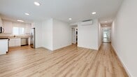 Located at 730 S Kingsley Dr in Los Angeles, this thoughtfully designed 2-bedroom, 2-bathroom single-floor unit offers a clean, modern aesthetic throughout. Light wood vinyl flooring flows seamlessly across all rooms, complemented by crisp white walls and recessed lighting that create a bright, airy atmosphere.

The open-concept living, dining, and kitchen area serves as the heart of the home. Large windows flood the space with natural light and offer views of the surrounding neighborhood. The kitchen features white shaker cabinetry, light countertops, a stainless steel dishwasher, gas range, and microwave, providing a functional and stylish cooking environment.

Both bedrooms are well-proportioned and finished with the same light flooring and neutral palette. Each room is equipped with full-width mirrored sliding closet doors that enhance the sense of space. Windows with blinds allow for natural light and privacy control. The primary bedroom offers a comfortable footprint suitable for standard furnishings.

The two bathrooms are identically appointed with white vanity cabinetry, white countertops, large mirrors, and shower-tub combinations — maintaining the unit's clean, cohesive design. A dedicated laundry area and four closets provide ample storage. A central hallway connects all rooms efficiently, completing this well-organized and move-in-ready Los Angeles home.