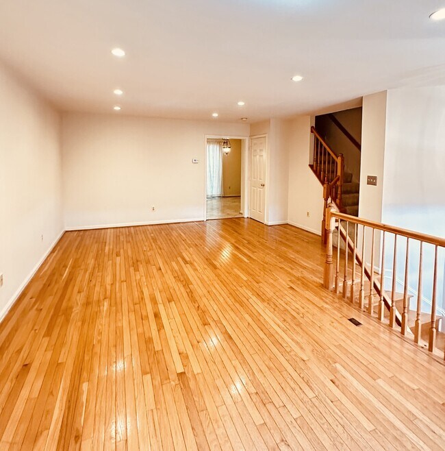 Living room and dining room with hardwood floors - 397 S Pickett St Townhome
