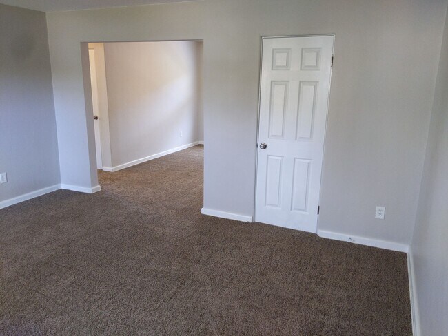 Living room looking toward dining room (front closet shown) - 1224 North Plum Street