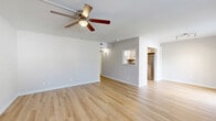 Located at 75 Nightingale Dr in Gulf Breeze, FL, this single-floor, 2-bedroom, 2-bathroom home offers a clean, modern aesthetic throughout. Light wood laminate flooring runs continuously across the living spaces, creating a cohesive and bright atmosphere. The combined dining and living area is open and well-proportioned, featuring a ceiling fan with light fixture and a pass-through window that connects seamlessly to the kitchen, enhancing the sense of openness. The kitchen is efficiently designed in a U-shape layout, outfitted with white cabinetry, dark granite countertops, stainless steel appliances including a refrigerator and range, and a stainless steel sink — offering a sleek, functional workspace. Both bedrooms are comfortably sized, each with ceiling fans, neutral gray walls, and natural light from windows with blinds. The primary bedroom is generously proportioned and includes closet access. The two bathrooms differ in style: one features a tub-shower combination with chrome fixtures and classic white tile, while the other offers a vanity with dark granite countertops, white cabinetry, and matching wood flooring. A hallway, closet, and patio round out the layout, completing this well-organized and move-in-ready home.